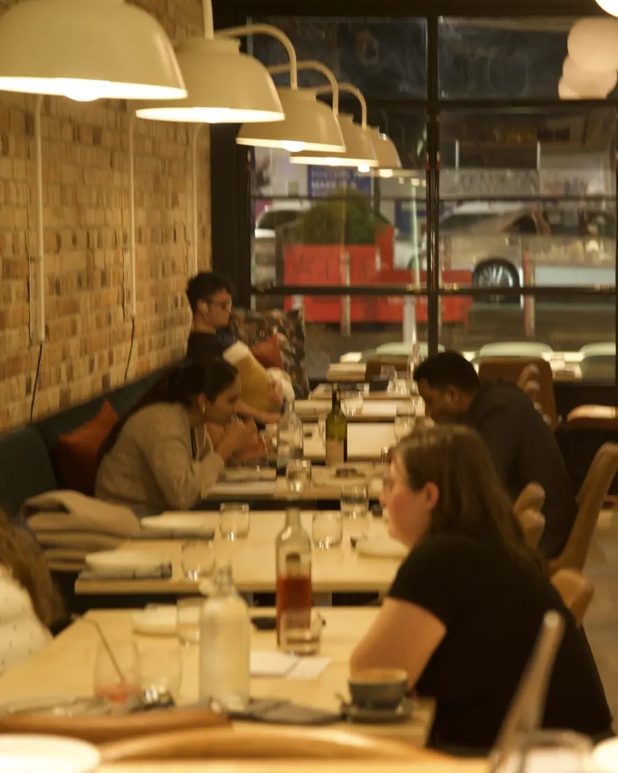 Guests at the tables in Little Honey’s dining room
